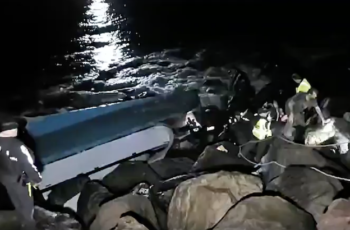 Three rescued in Oregon from overturned crab boat The first crewman to emerge from the overturned Pacific Miner reaches the top of a Coos Bay jetty after firefighters sawed a hole in the hull. Video still courtesy Basin Tackle Charleston.
